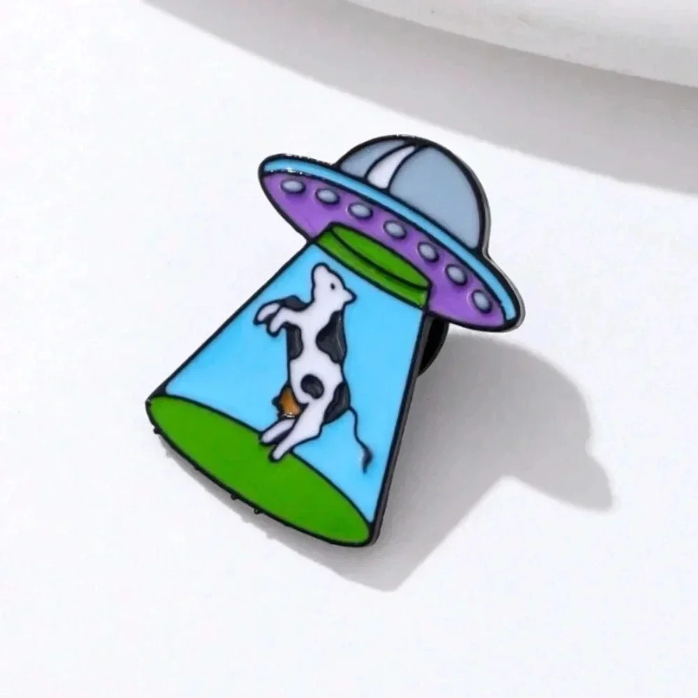 COPY - Funny black white cow abducted by blue green alien spaceship enamel broo…